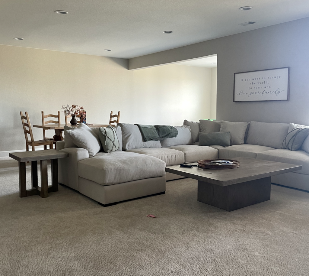 A basement living room painted with Sherwin-Williams Accessible Beige paint. 