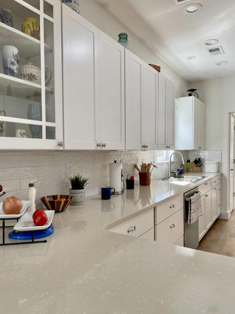 A kitchen features BM Oxford White cabinets with BM Simply White walls. 