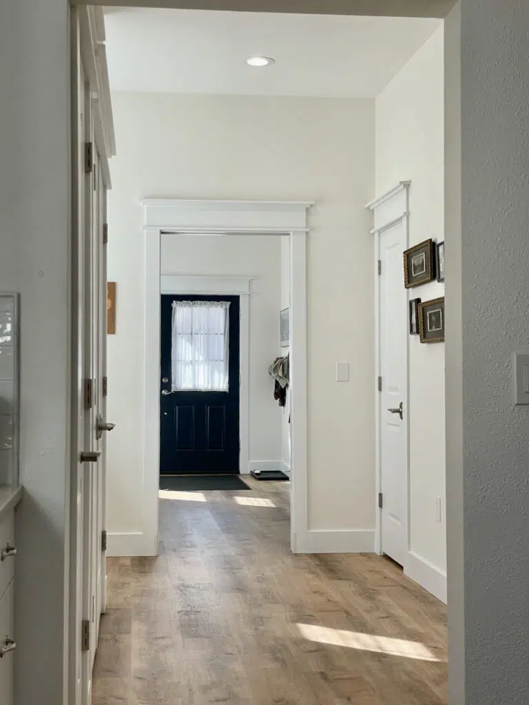 An open concept living area with a Benjamin Moore Simply White color palette