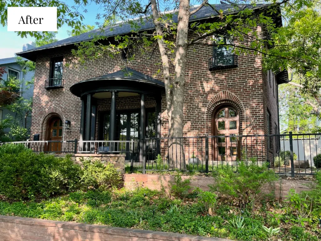 A red brick home painted with black trim