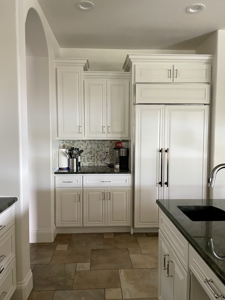 A kitchen includes BM Swiss Coffee cabinets and Swiss Coffee walls for a monochromatic kitchen look.
