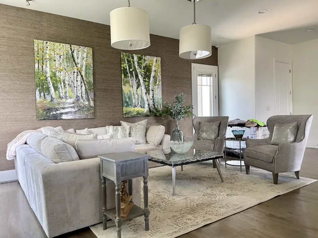 A living room painted with BM Swiss Coffee paint and brown wallpaper.