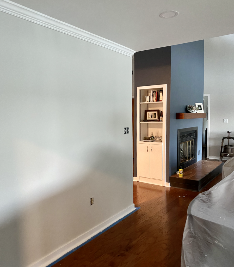SW Grey Heron walls are pictured with an SW Granite Peak accent wall and SW Pure White built-in bookshelf.