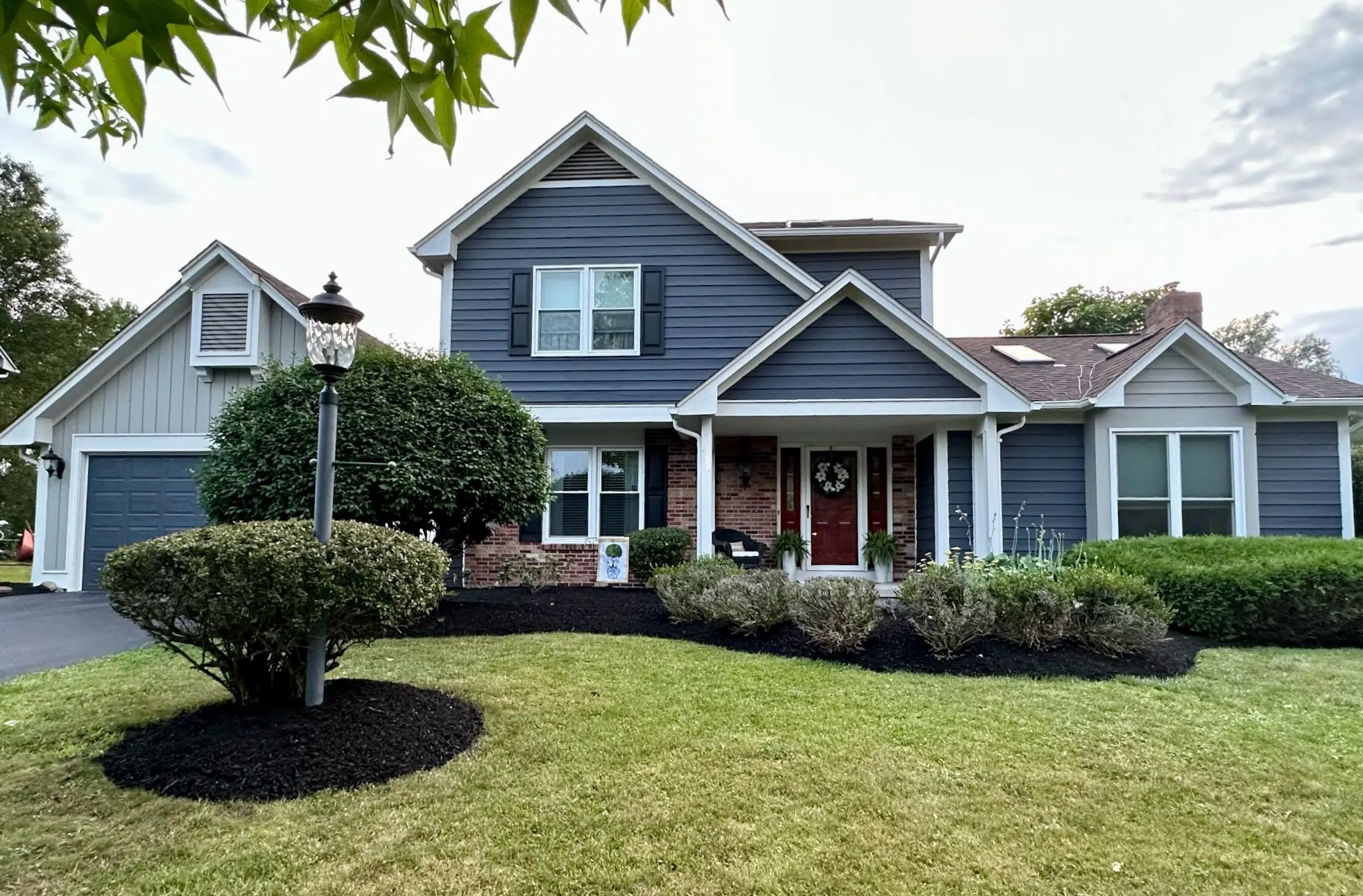 A home featuring a Sherwin-Williams exterior color scheme with SW Cyberspace paint