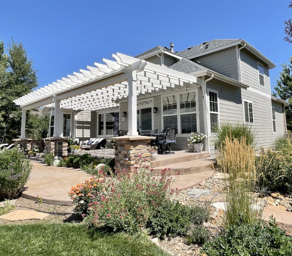 A Colorado home is painted with SW Intellectual Gray siding and SW Egret White pergola over the patio