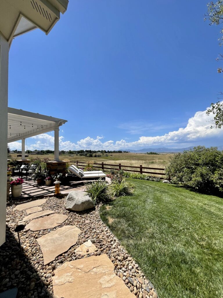 A Colorado home with Egret White pergola overlooks fields and mountains