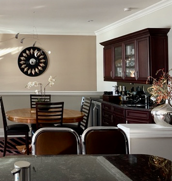 A dining room painted with Benjamin Moore Natural Cream and beige accent color.