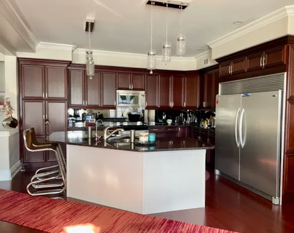 A kitchen with dark wood cabinets is painted with Benjamin Moore Natural Cream paint. 