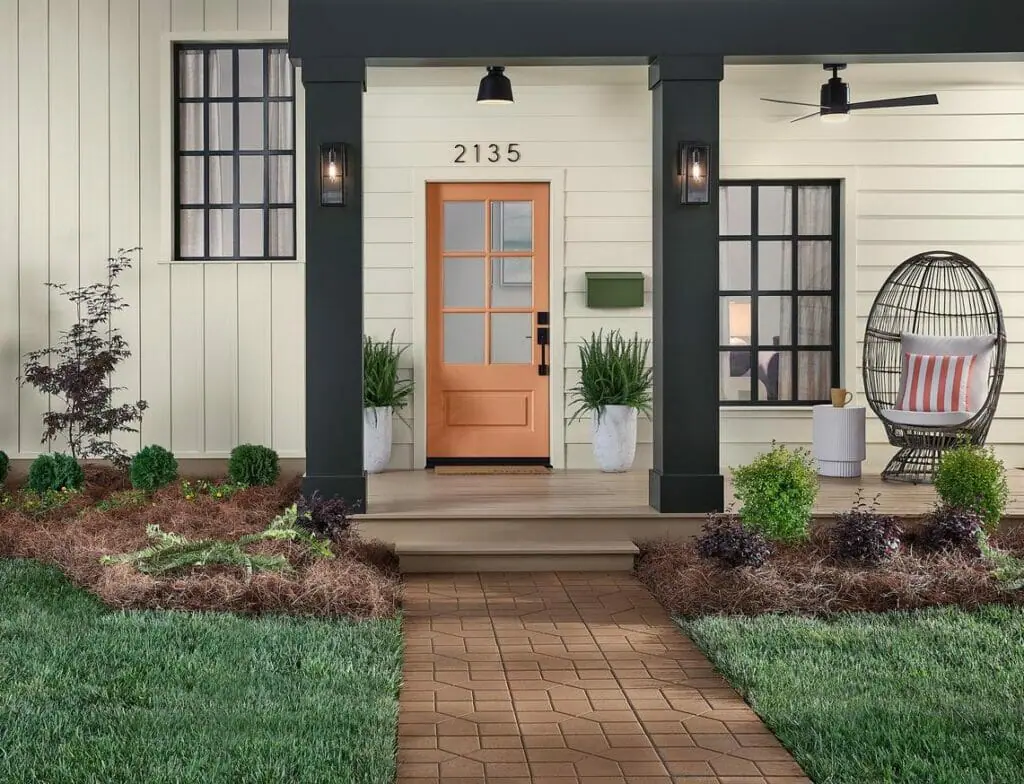 Creamy exterior with Persimmon front door.