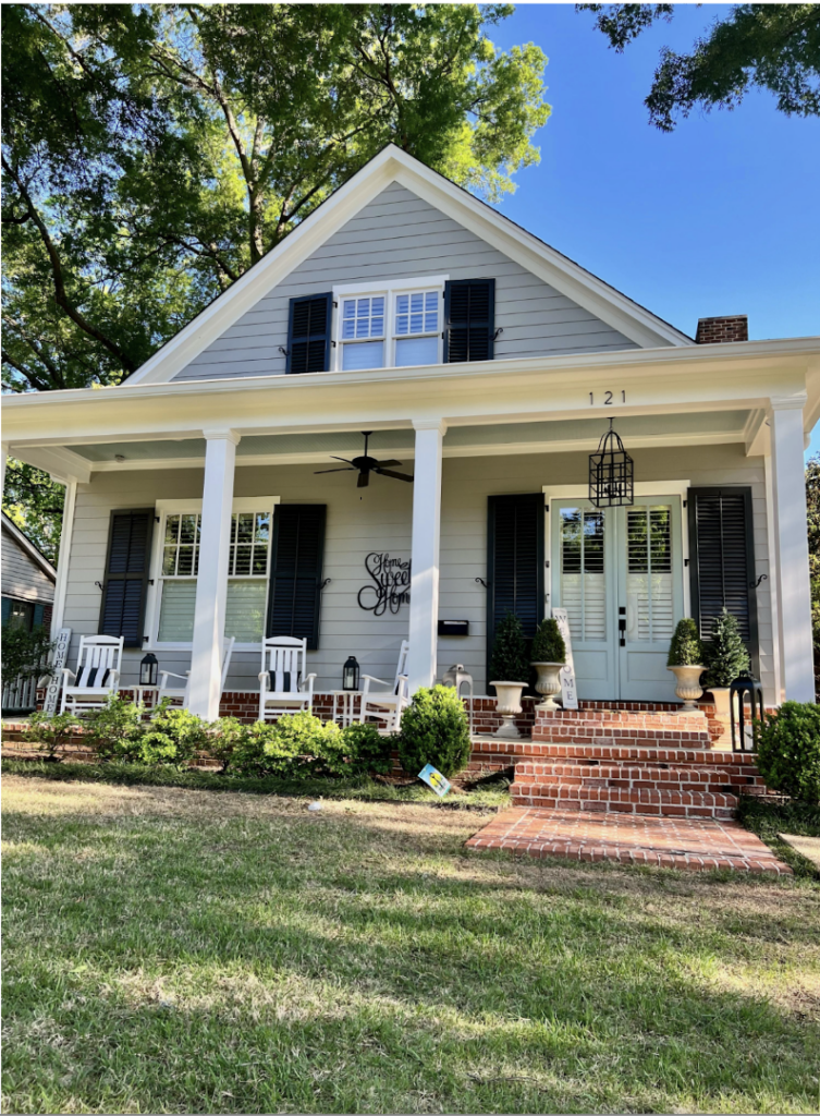 A home painted with gray exterior color paint and BM Wedgewood Gray haint blue porch paint