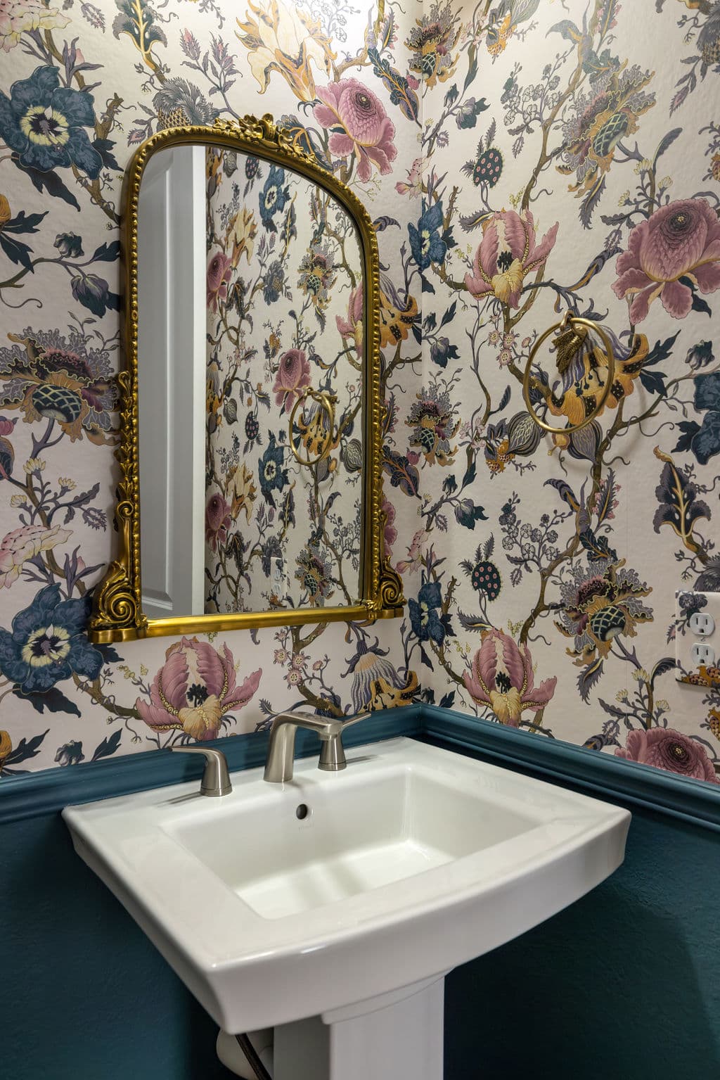 A powder room featuring white sink, floral wallpaper and BM Bella Blue wainscoting.
