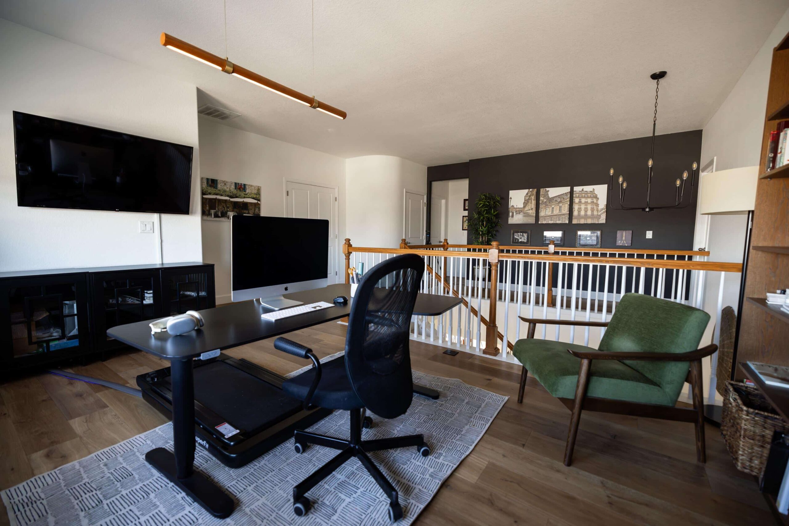 An office painted with Sherwin-Williams Cheviot paint with an SW Iron Ore accent wall.