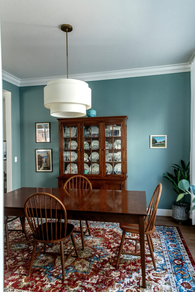 A dining room is painted with Farrow & Ball Oval Room Blue paint.