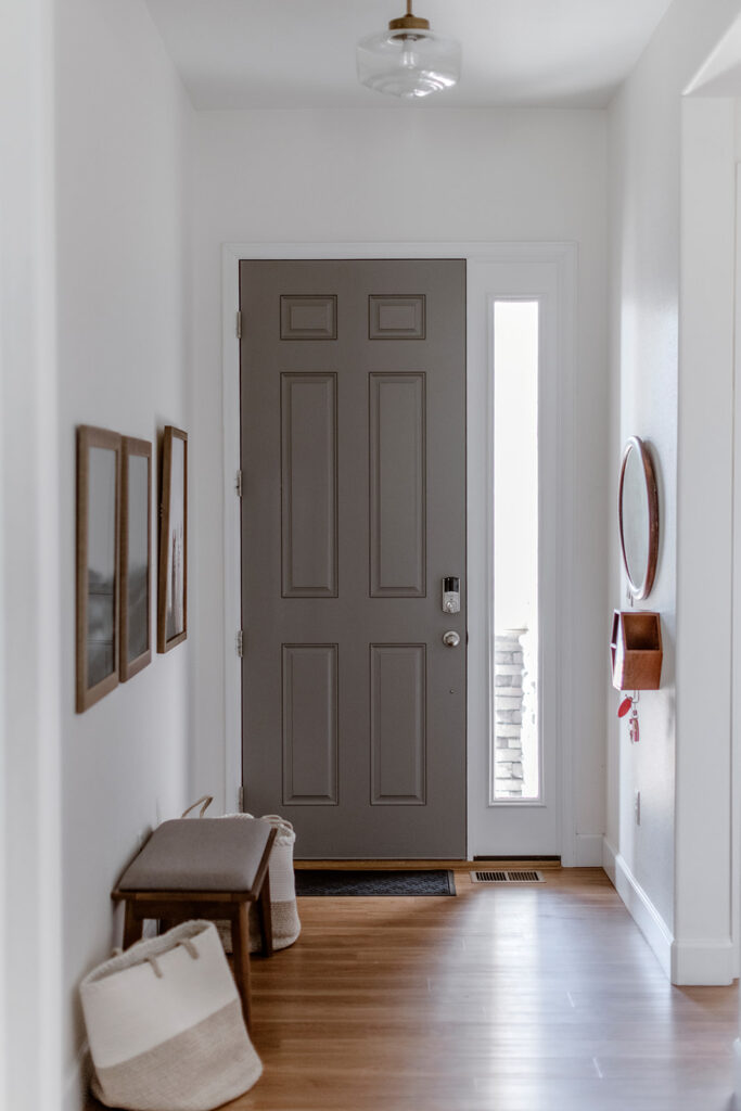 A Chelsea Gray interior front door is paired with BM Simply White walls.