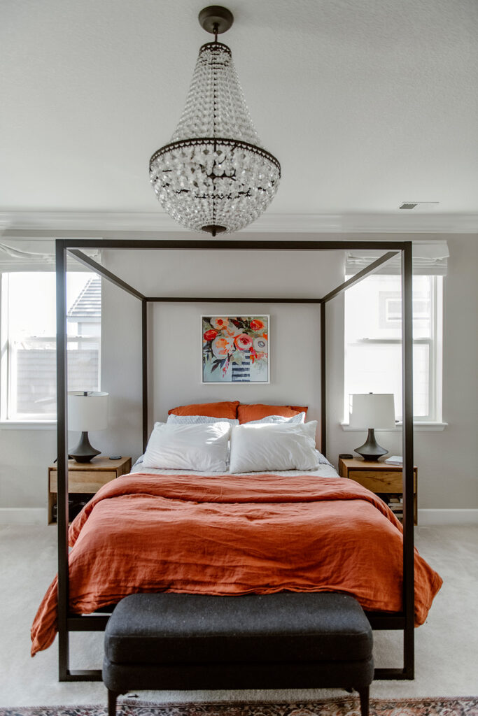 A master bedroom is painted with SW Agreeable Gray walls