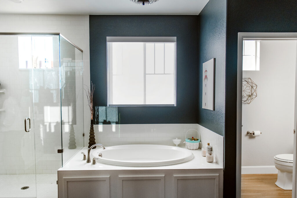 A blue and white master bathroom features SW Cyberspace walls