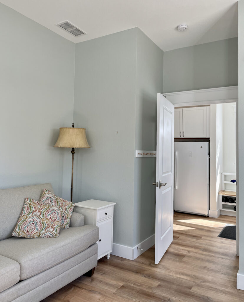 A living room is painted with Benjamin Moore Gray Cashmere, one of the best blue-gray paint colors.
