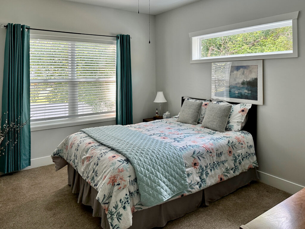 A bedroom is painted with Sherwin-Williams First Star, one of the best blue-gray paint colors.