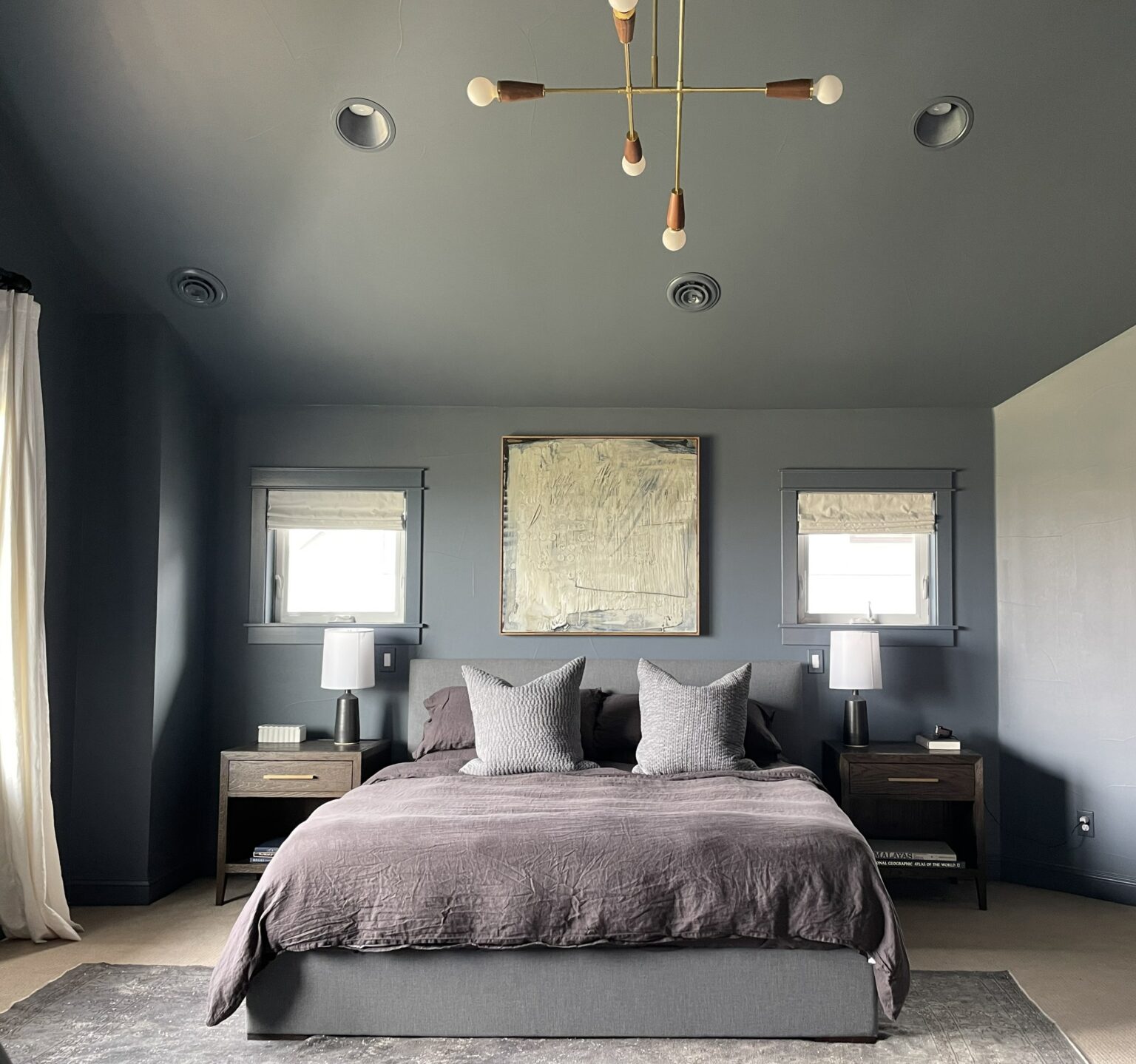 A bedroom is painted with BM Granite Peak on the walls and ceiling.