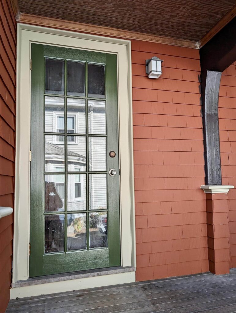 A Boston home is painted with BM Earthly Russet brown exterior paint and BM Windsor Green front door paint.