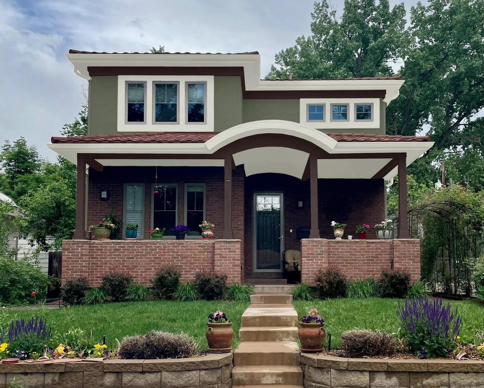 A home is shown painted with Sherwin-Williams Rosemary exterior paint with red brick.
