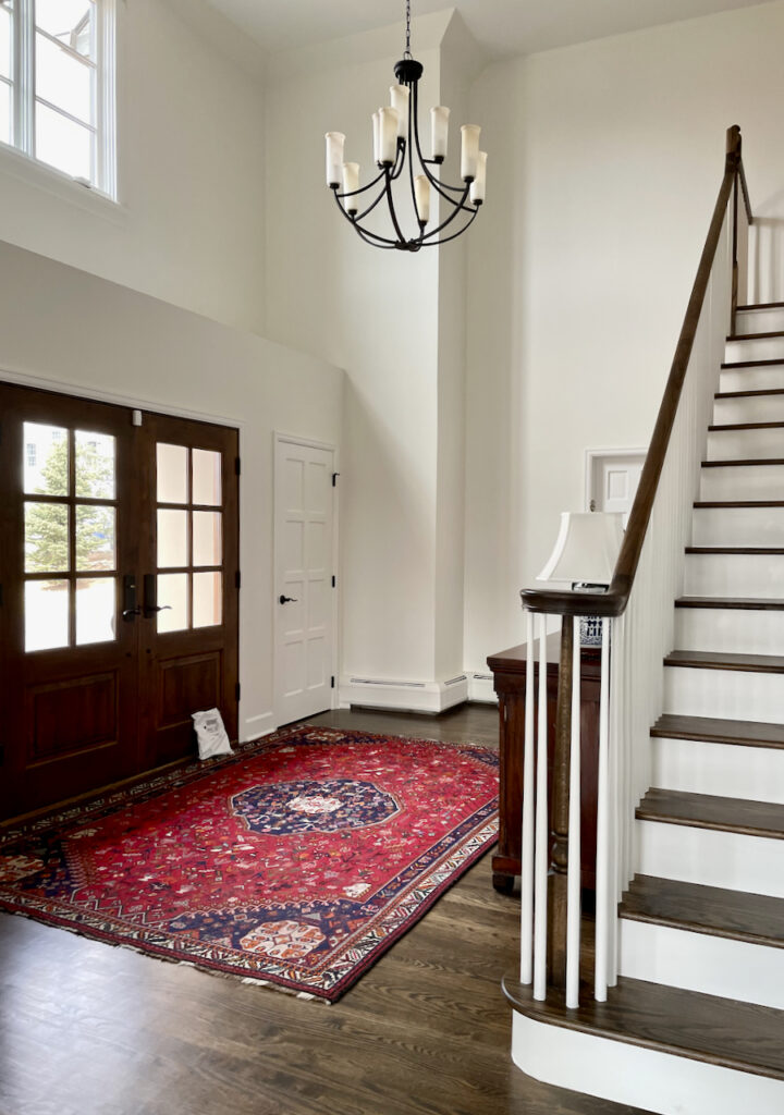 An entryway features Benjamin Moore White Dove paint