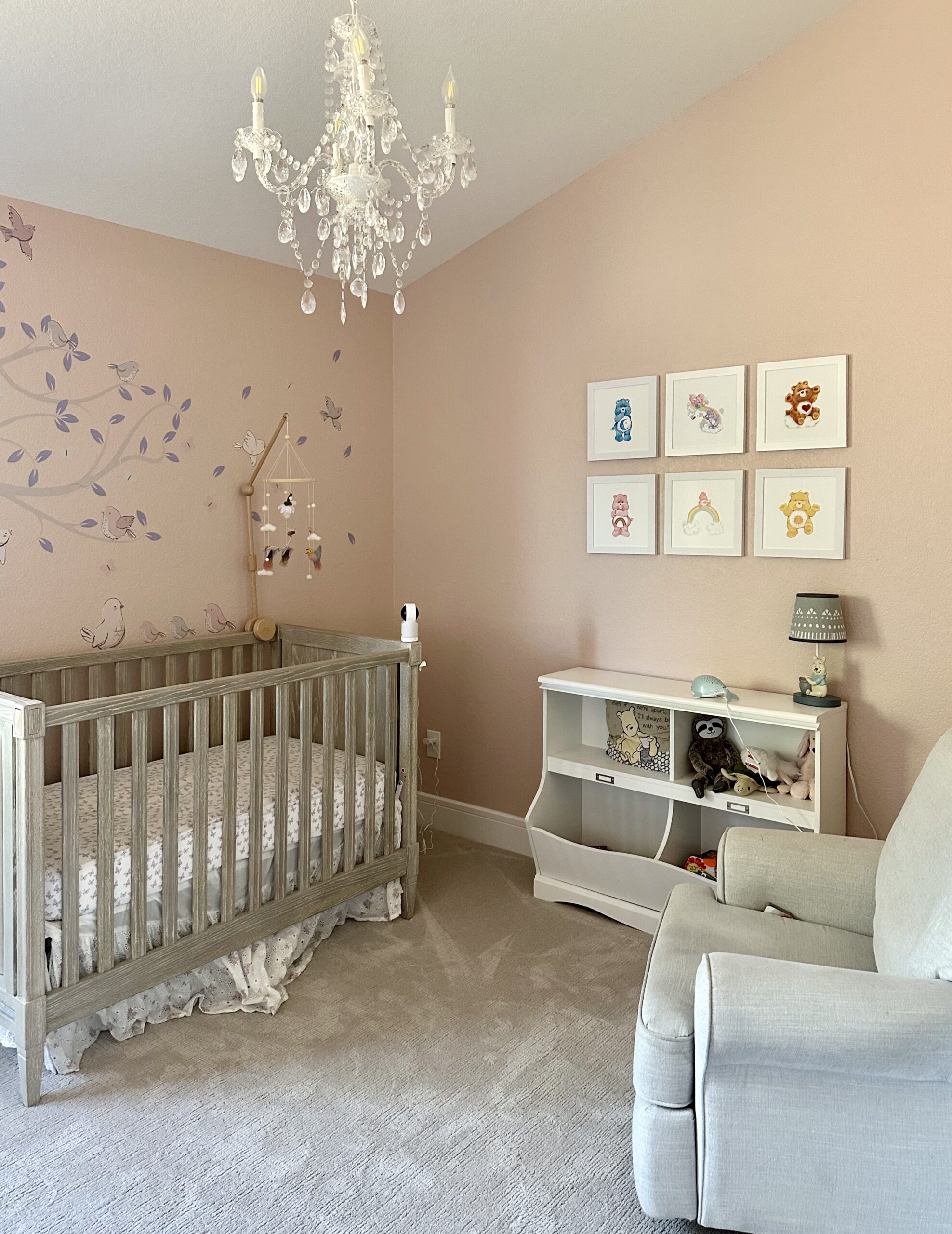 A nursery is painted with Sherwin-Williams Pink Shadow paint.