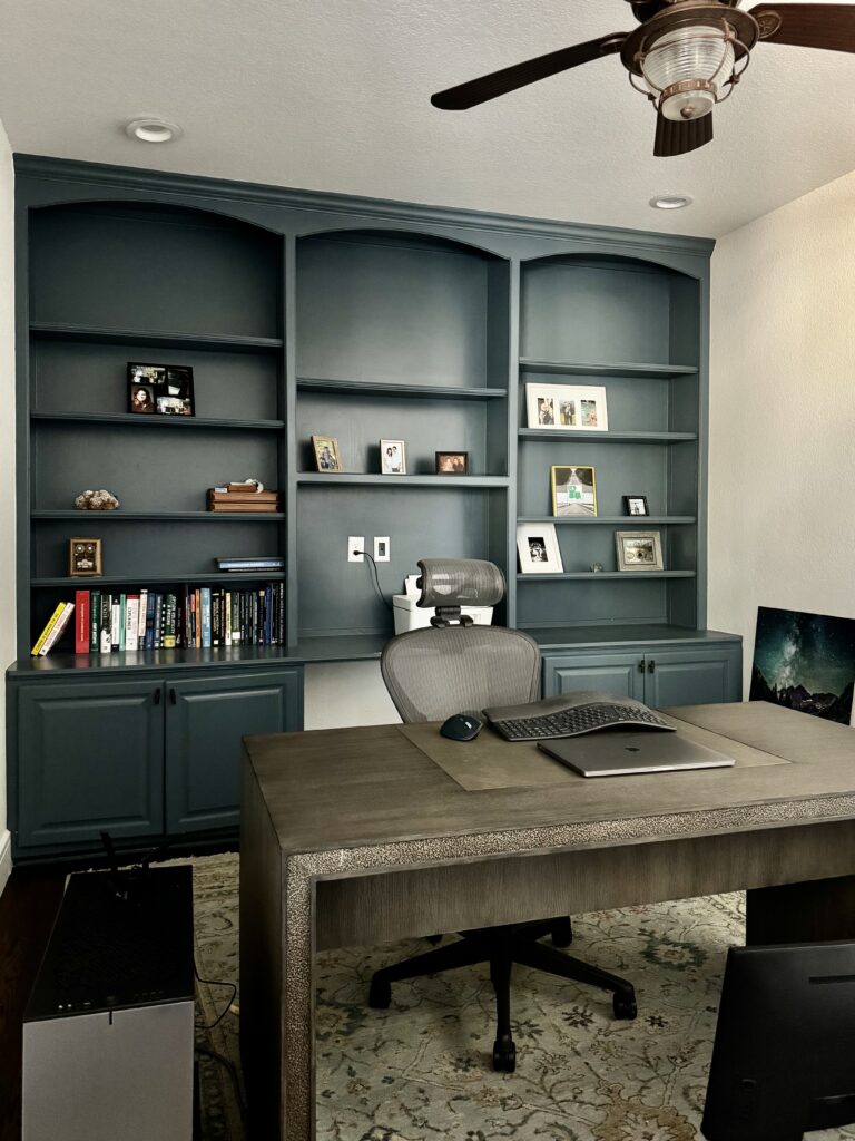 An office features SW Greek Villa walls and SW Needlepoint Navy built-in cabinets.