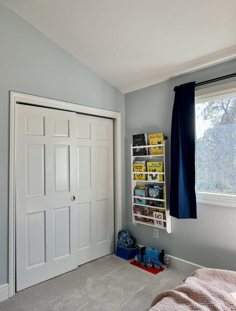 A boys bedroom is painted with Sherwin-Williams Lullaby blue paint