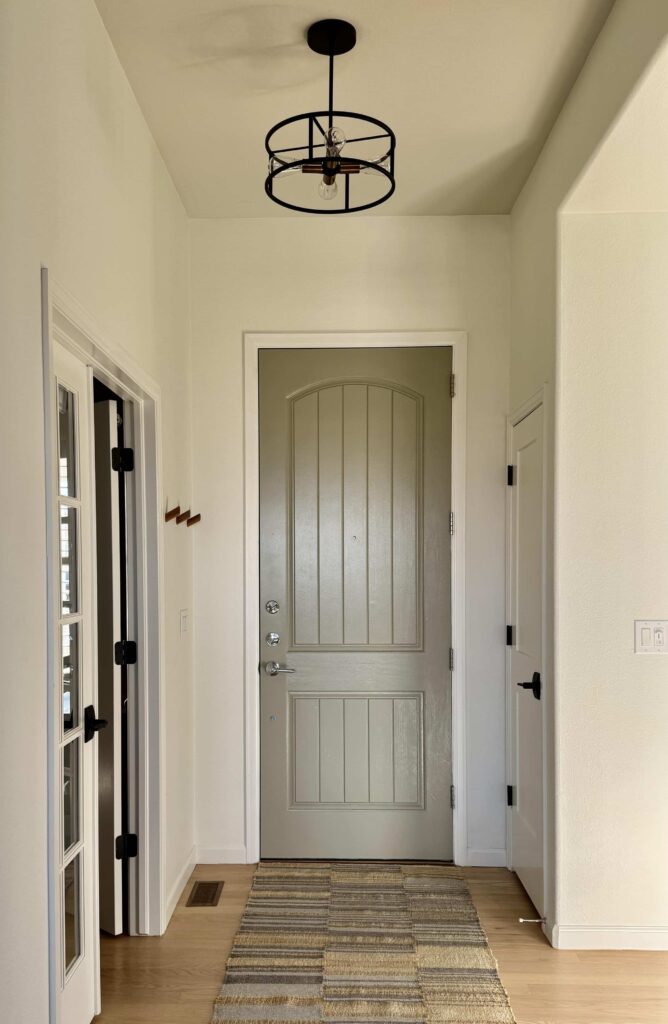 A home's front entryway is painted with SW Alabaster walls. 