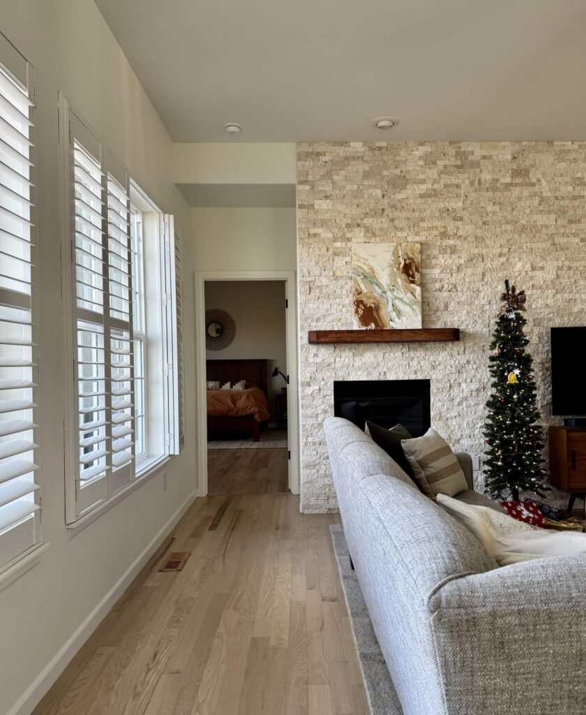 A home features SW Alabaster walls with a limestone accent wall. 