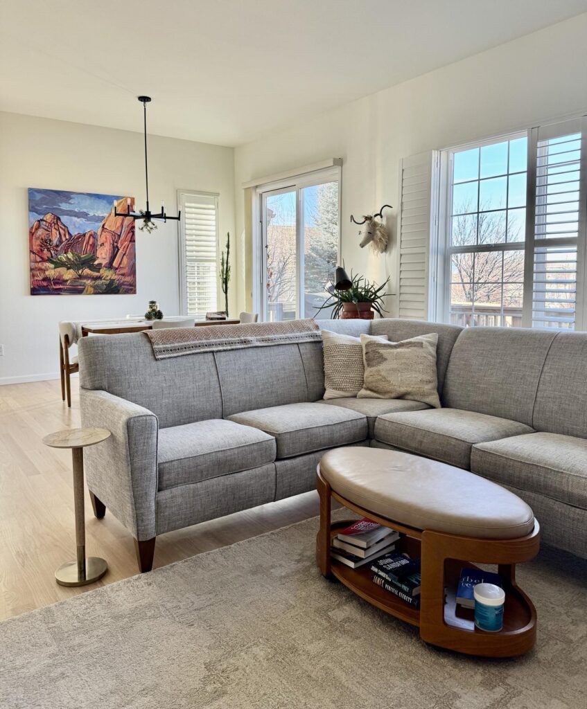 An open concept living room features SW Alabaster walls.