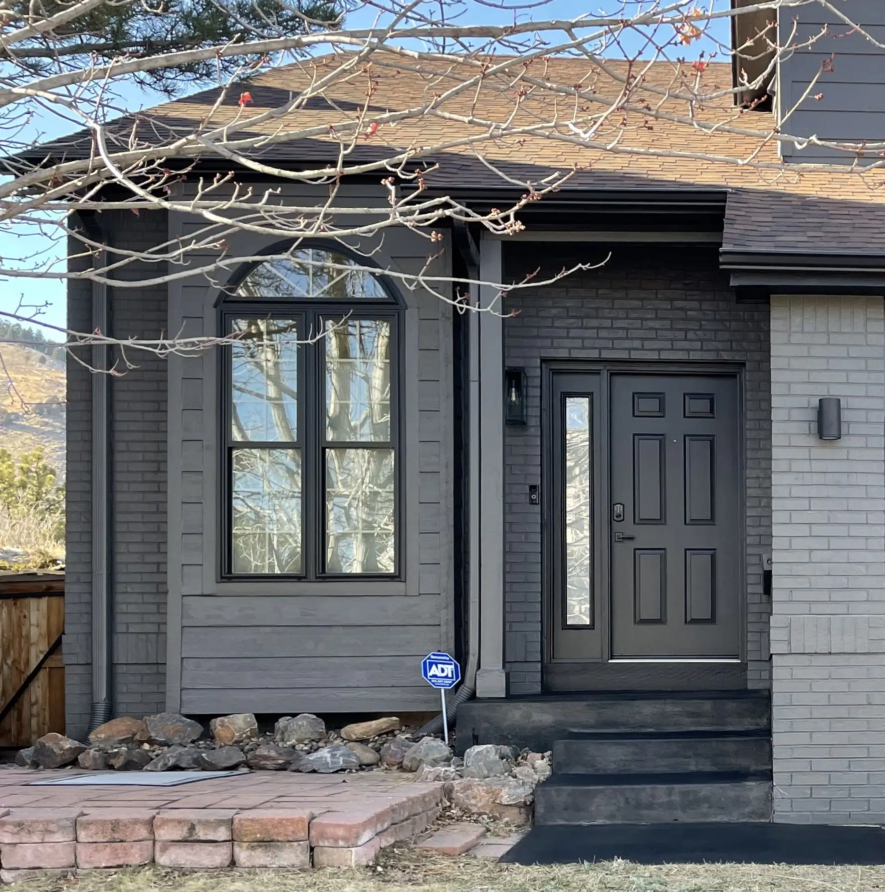 A home features BM Iron Mountain siding and a SW Black Magic front door.