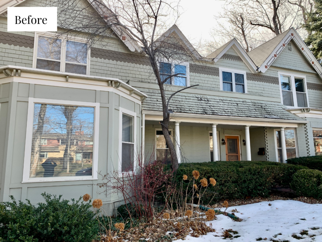 A historic home exterior features beige paint and white trim