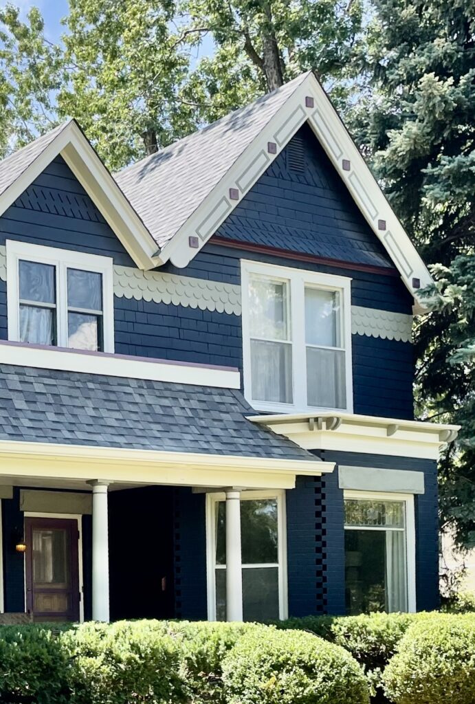 A Colorado home features a BM Westcott Navy exterior color palette, with BM Kasbah front door.