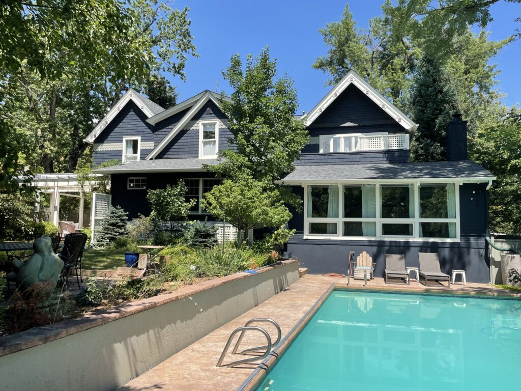 A home with a pool features a BM Westcott Navy exterior color palette.