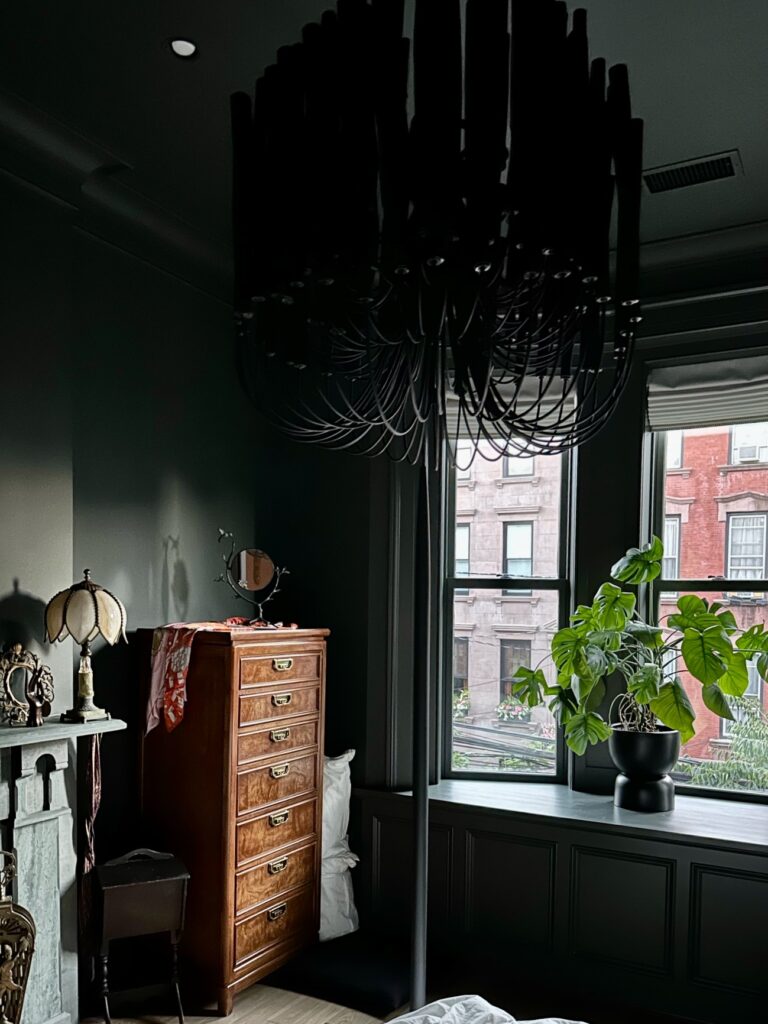 A color drenched bedroom is painted with Sherwin-Williams Rock Bottom dark green paint