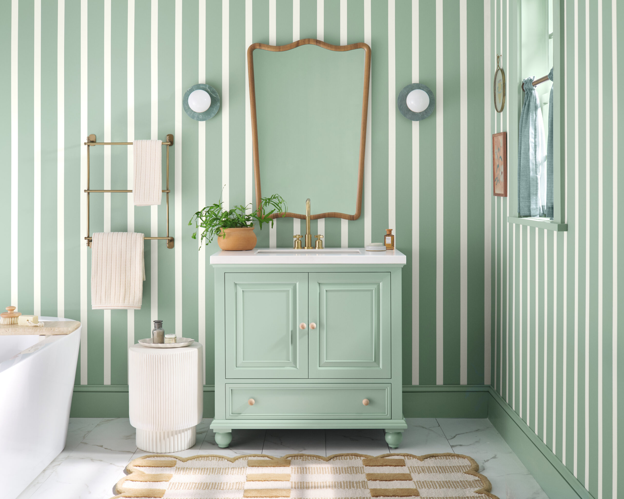 A SW Quietude bathroom features a painted vanity and color-drenched walls.