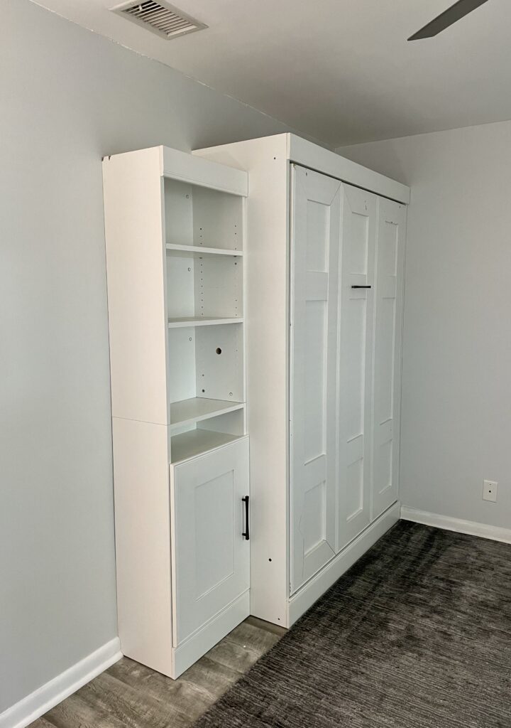 A bedroom features Benjamin Moore Intense White walls with brighter white cabinets.