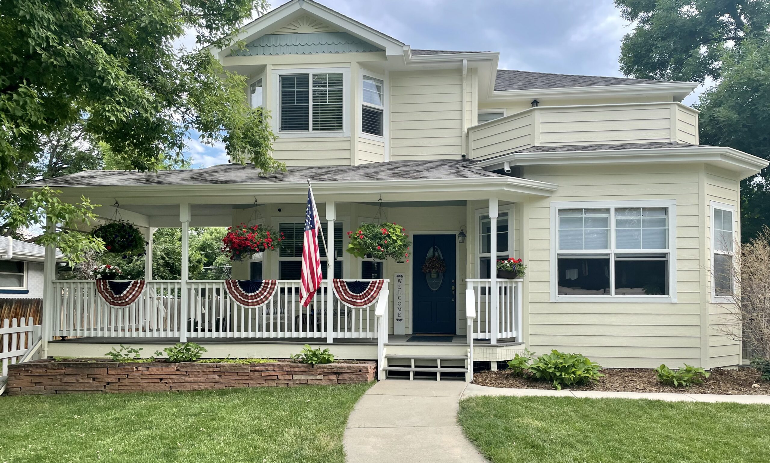 A home is painted with Sherwin-Williams Vital Yellow exterior paint.