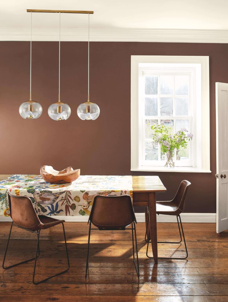 A dining room is painted with BM Leather Saddle Brown.