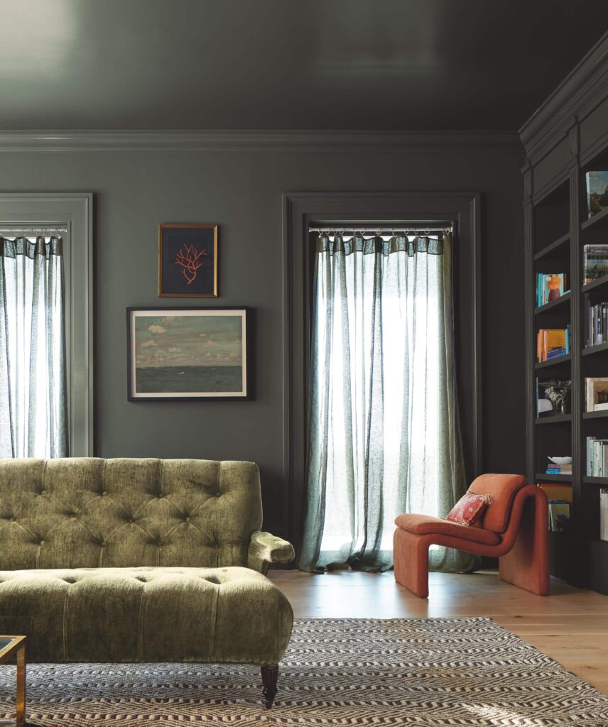 A home library features color drenching with BM Ashwood Moss paint. 