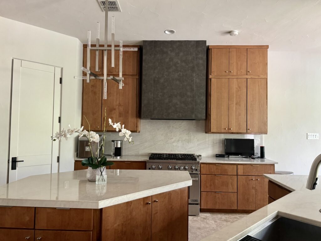 A kitchen features SW Egret White walls with wooden cabinets.