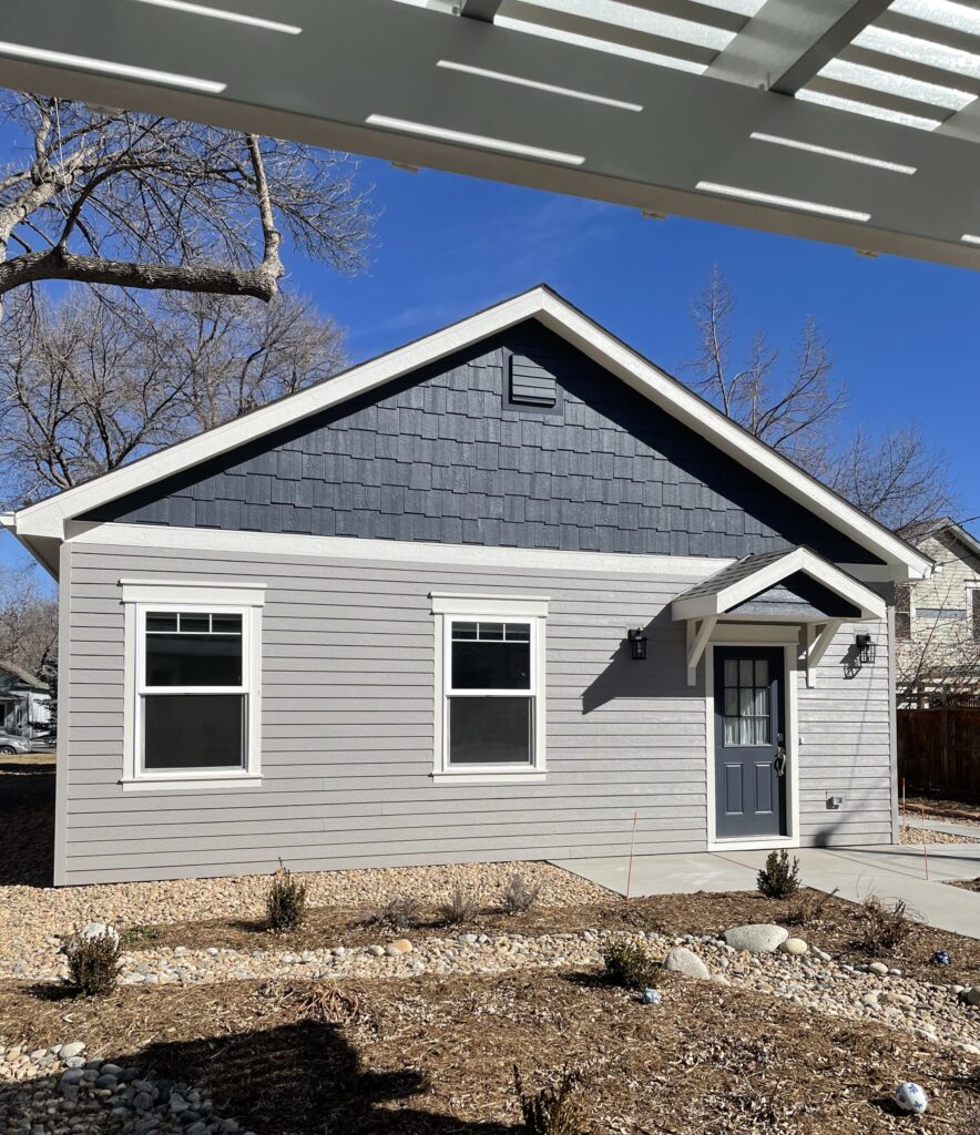 A home features Benjamin Moore Willow Creek exterior paint with BM Hale Navy accents, BM Classic Gray trim and a SW Stolen Kiss front door.