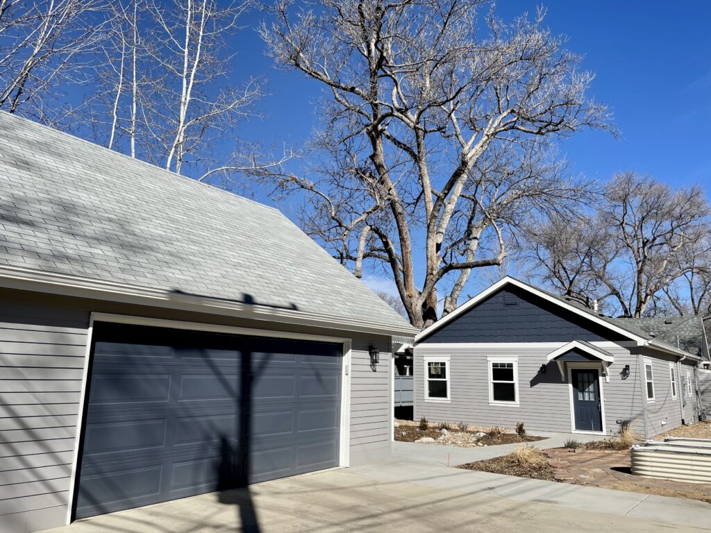 A home features Benjamin Moore Hale Navy exterior accent paint. 