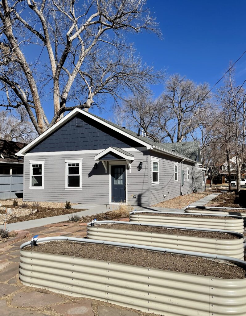 A home features Benjamin Moore Willow Creek exterior paint with BM Hale Navy and BM Classic Gray trim.