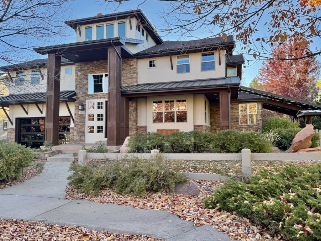 A home is painted with SW Accessible Beige exterior paint and SW Black Fox trim.