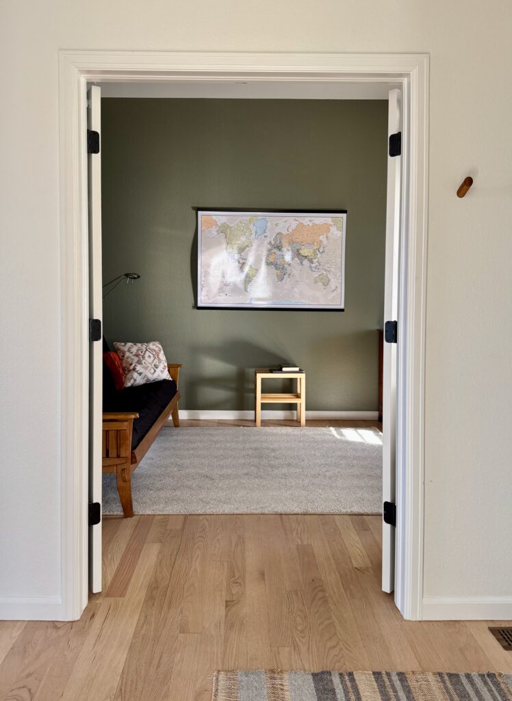 An olive green study is painted with Benjamin Moore Tate Olive.