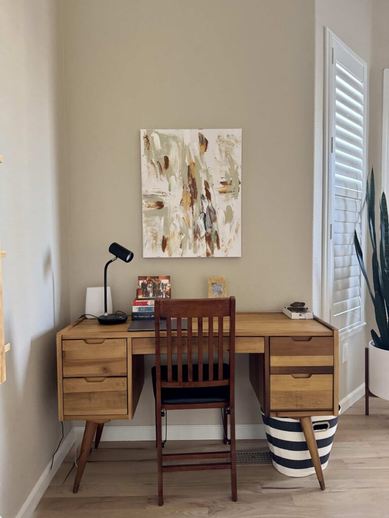 A home office features BM Natural Linen interior paint with natural wood desk.