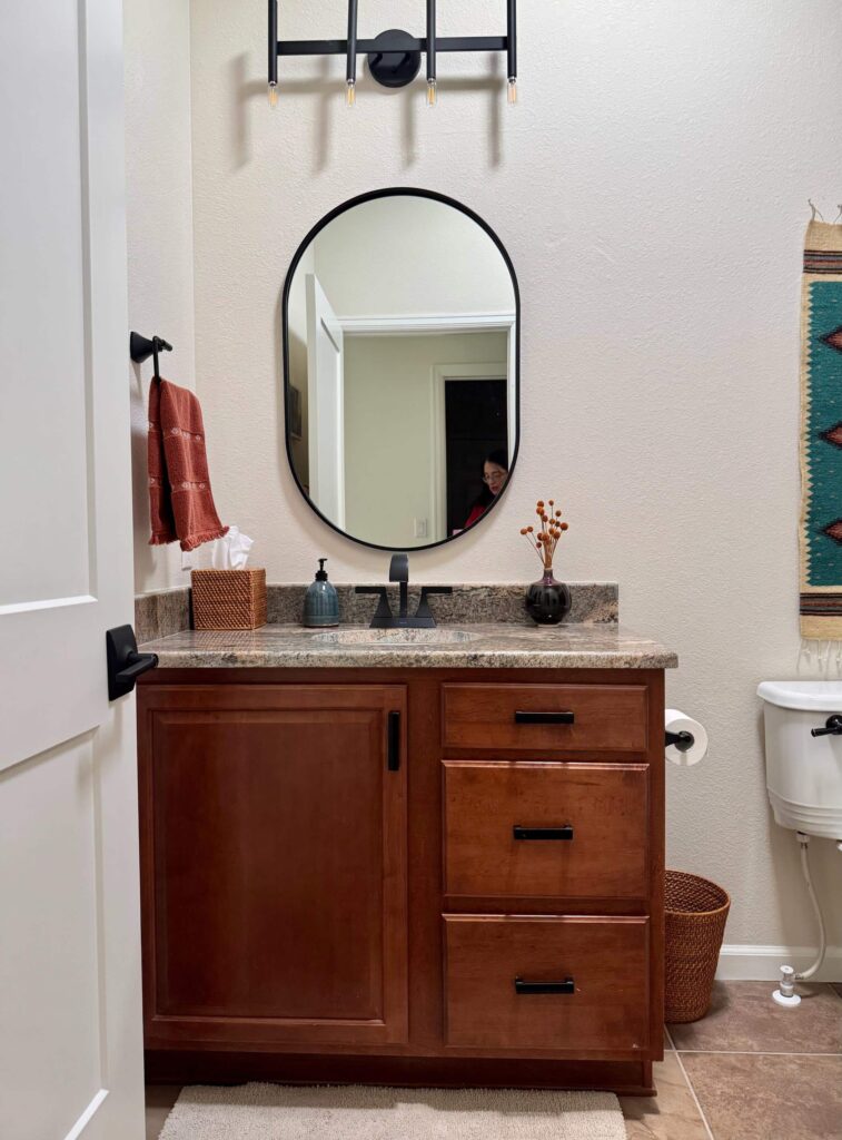 A BM Maritime White bathroom wall with vanity and black mirror. 